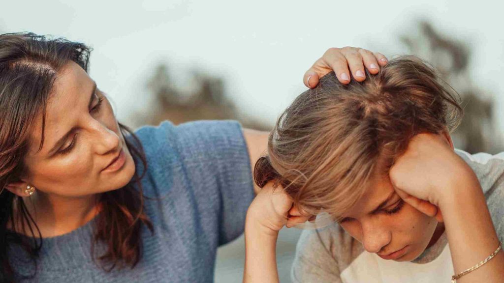 Mother comforting distressed teen, showing that treatment length depends on severity of the teen’s mental health condition.
